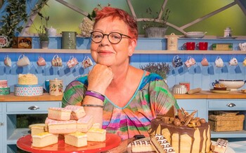 Host Jo Brand sits behind a selection of cakes on the Extra Slice set.